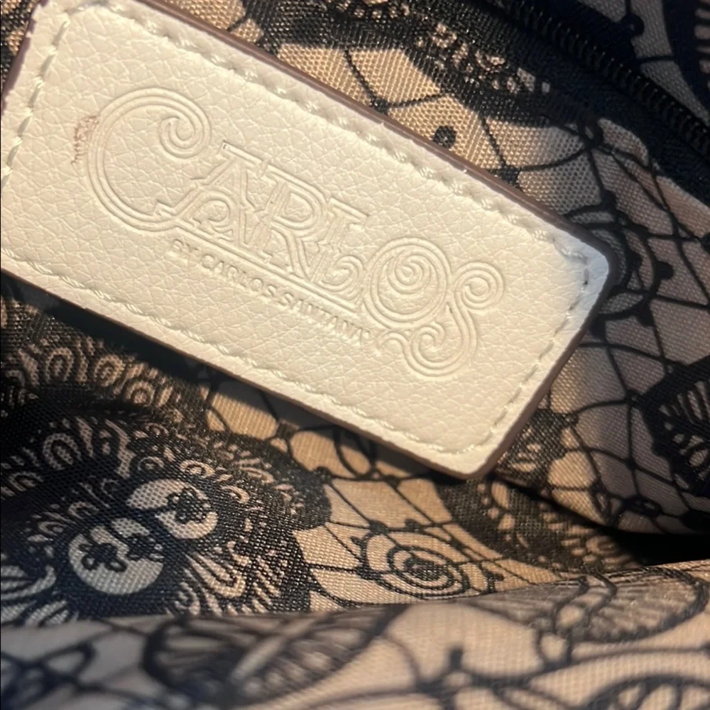 Carlos Santana White Textured Wristlet with Zipper Closure and rose medal accent